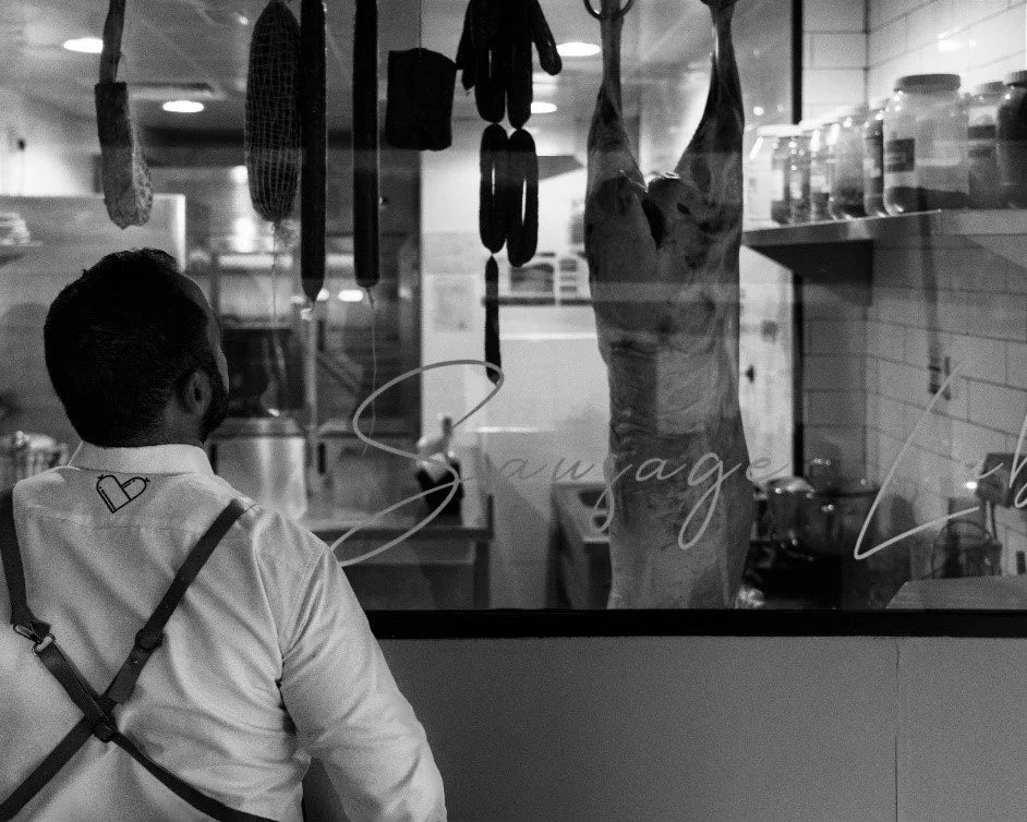 Person wearing suspenders in a kitchen setting with text overlay
