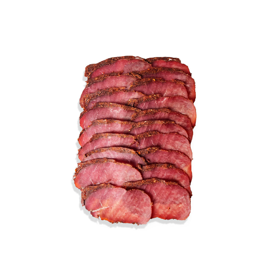 Sliced cured meat product on a white background