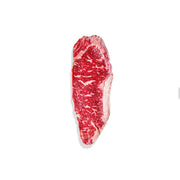 Raw steak with visible marbling on a white background