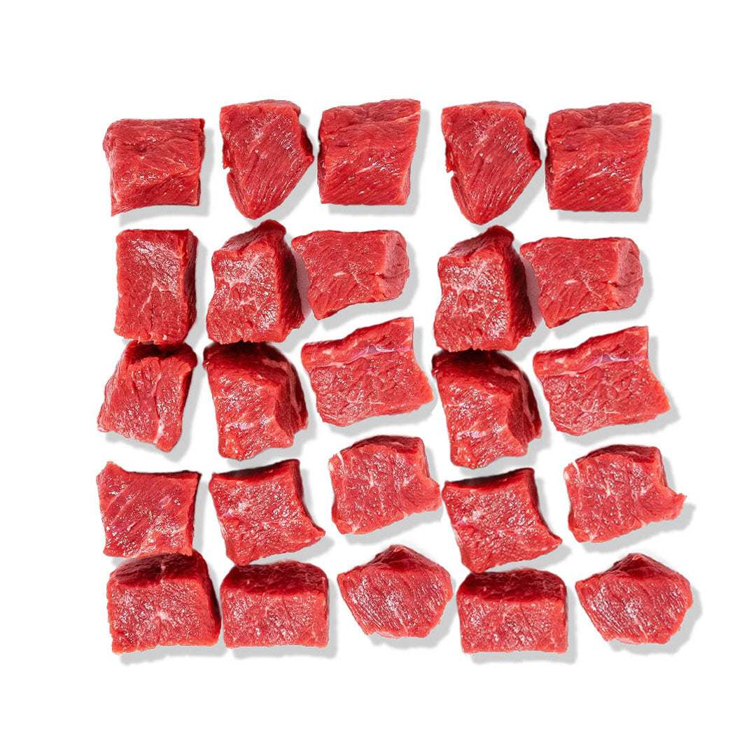 Raw beef cubes arranged in a grid on a white background