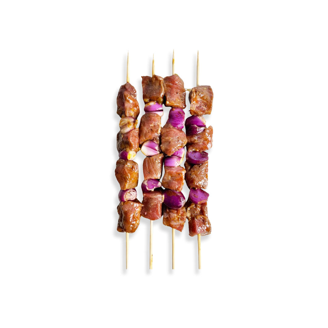Skewers with meat and vegetables on a white background