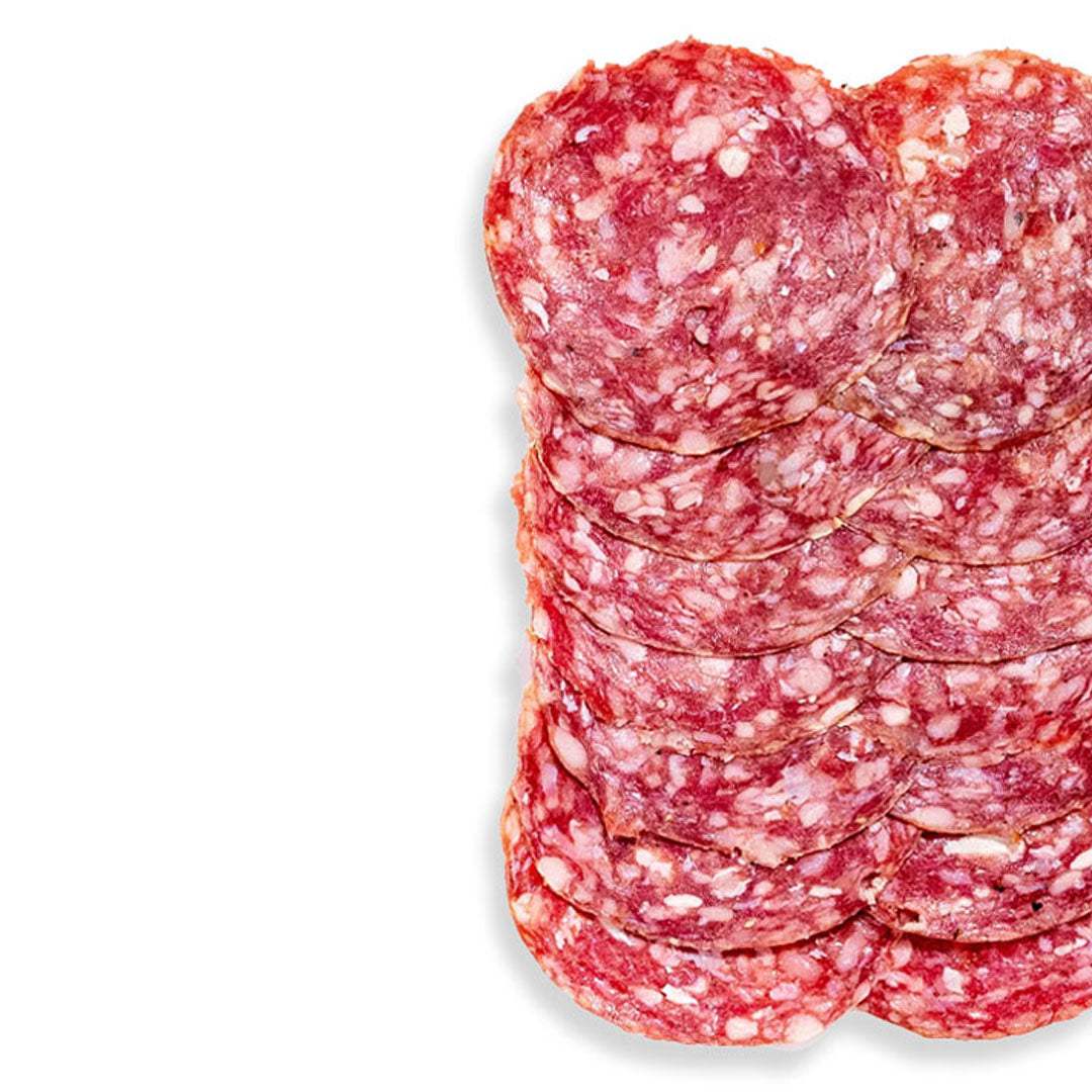 Stack of sliced salami on a white background