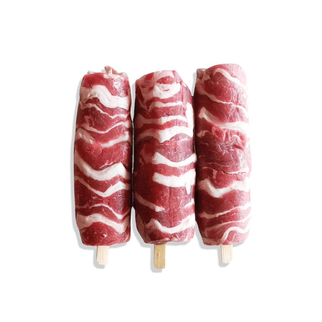 Three meat skewers with a white background
