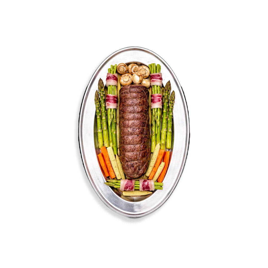 Decorative arrangement of meat and vegetables on a white background