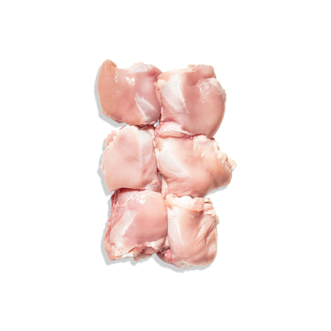 Raw chicken pieces on a white background