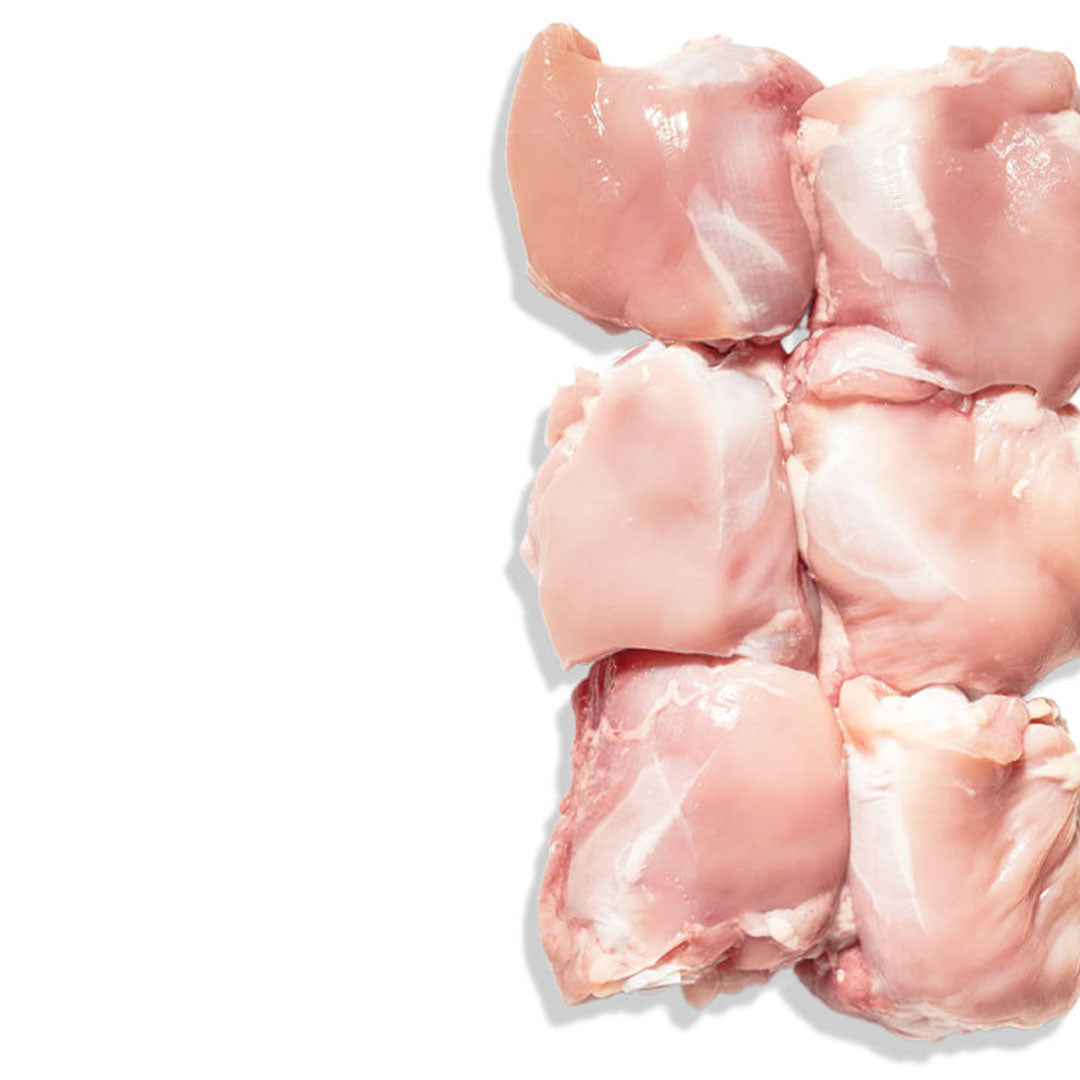 Raw chicken pieces on a white background