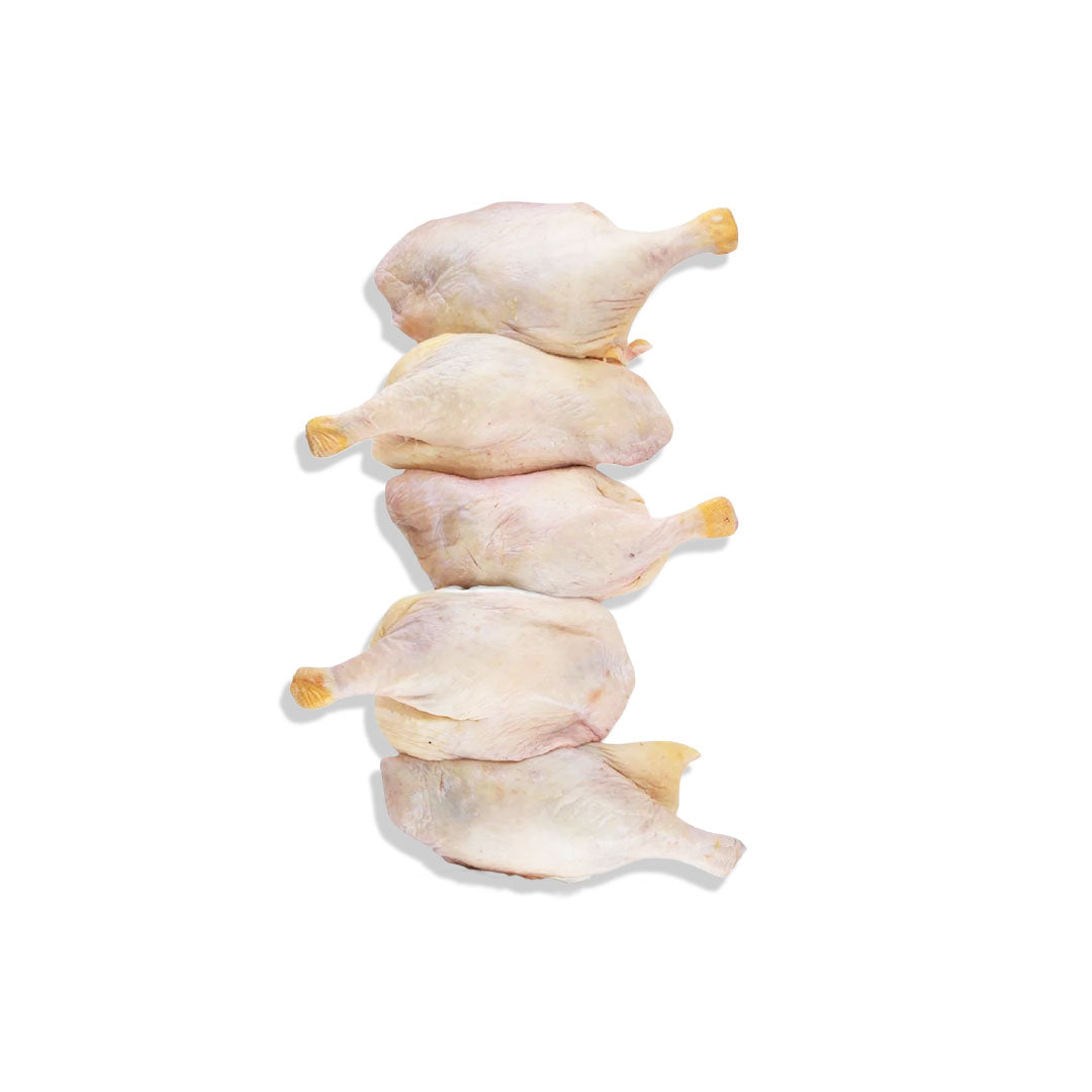 Four raw chicken legs stacked on a white background
