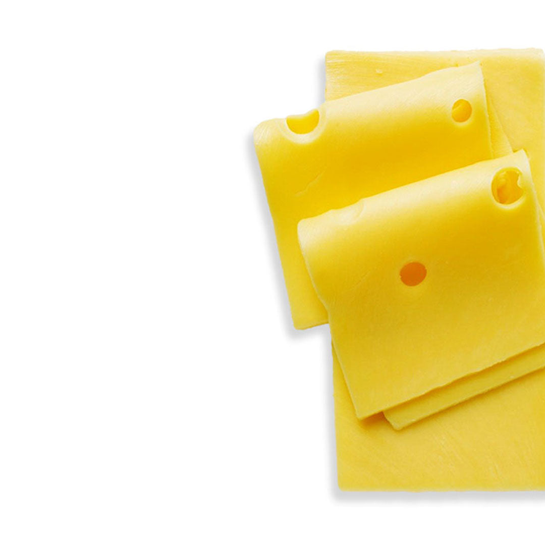 Swiss cheese slice with three holes on a white background