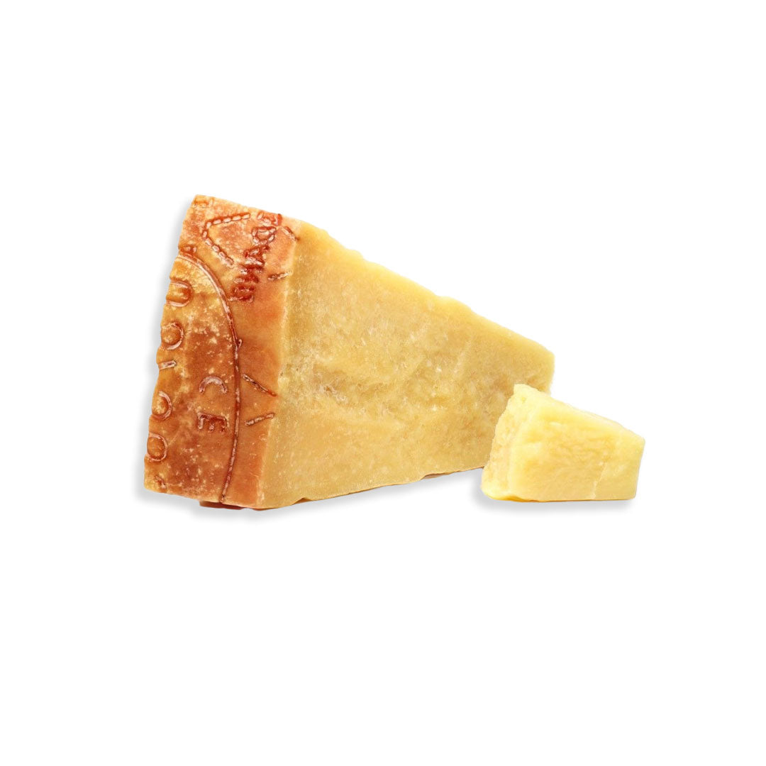 Block of Parmesan cheese with a small piece on a white background