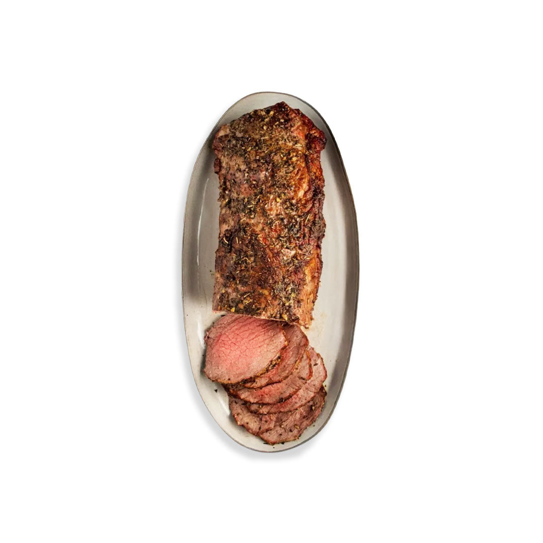 Sliced beef on a decorative plate with a white background