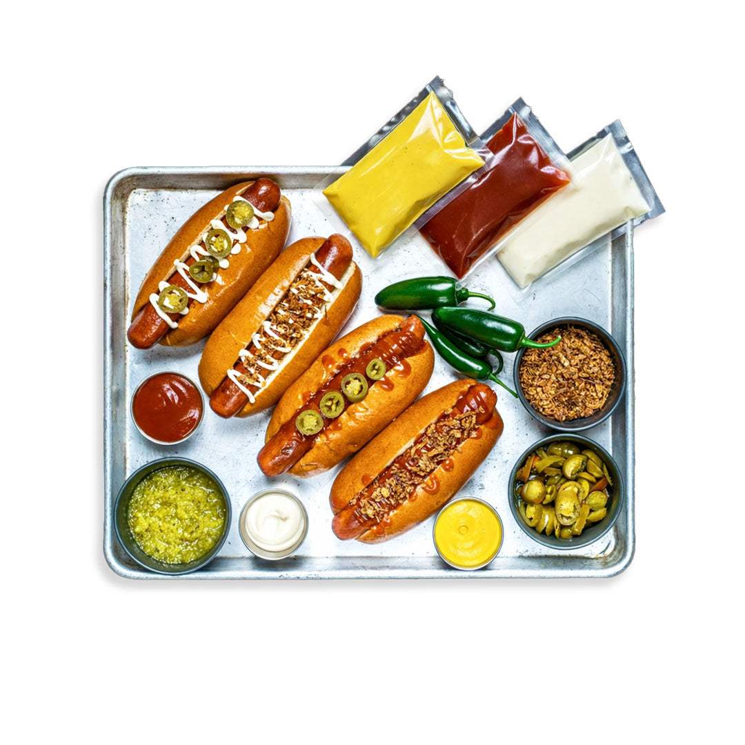 Hot Dog Box with American hot dogs, potato rolls, jalapeños, crispy onions, relish, and sauces for BBQ grilling