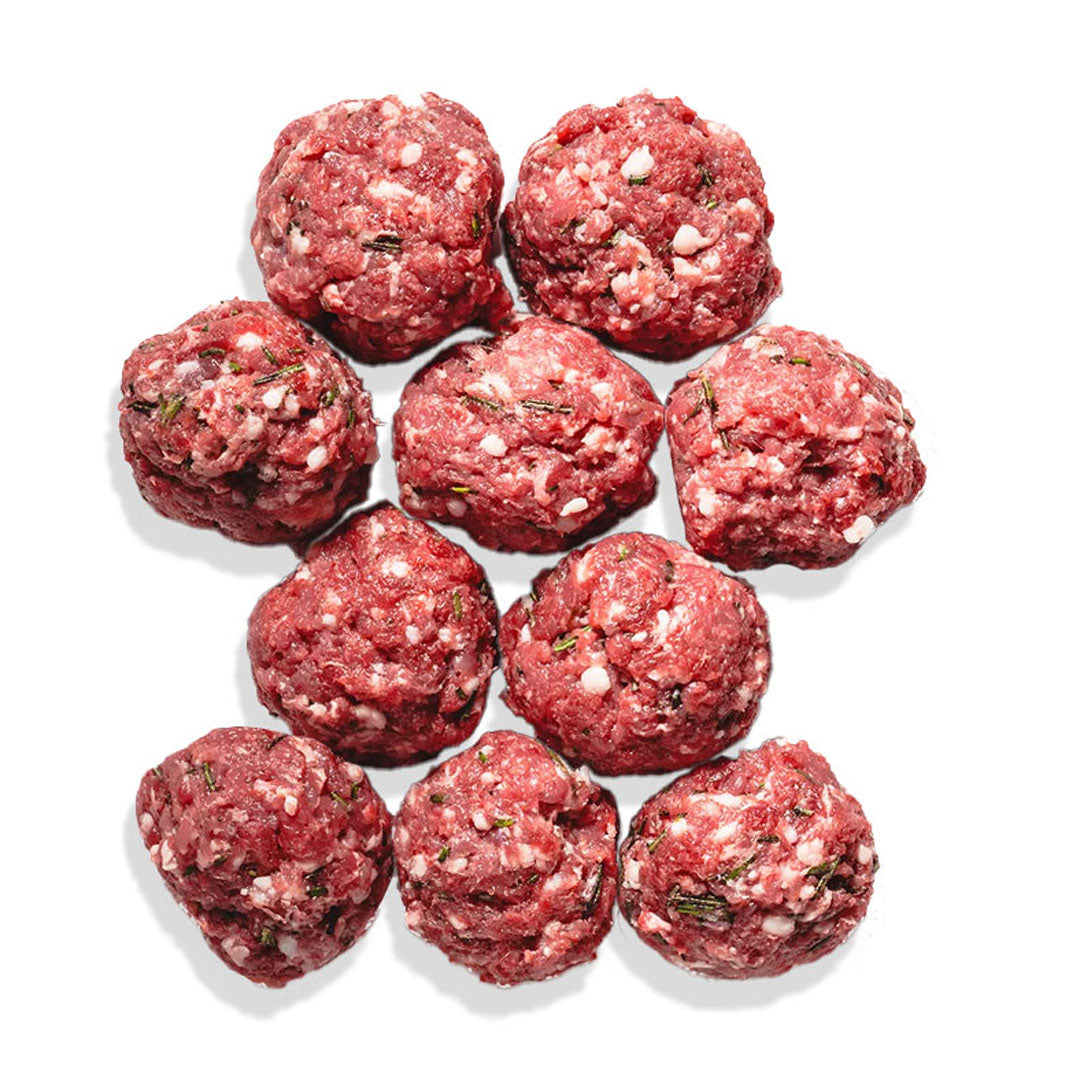 Raw ground meatballs arranged in a circular pattern on a white background