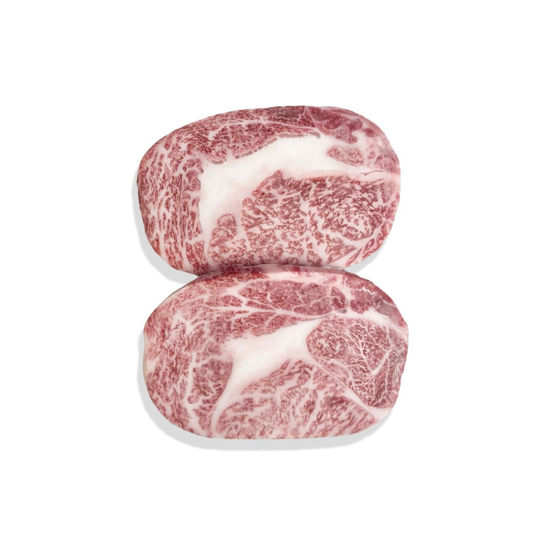 Two pieces of marbled beef on a white background
