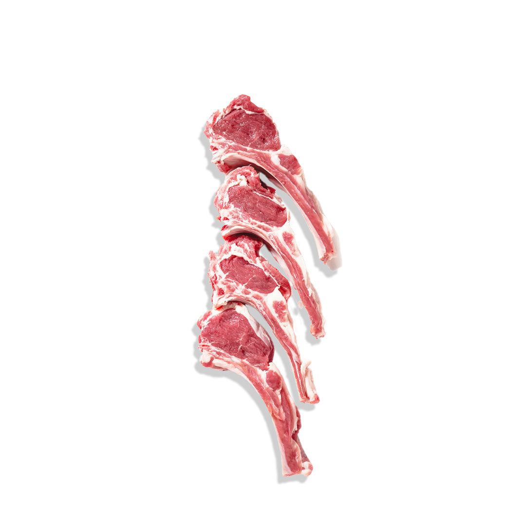 Three raw lamb chops on a white background