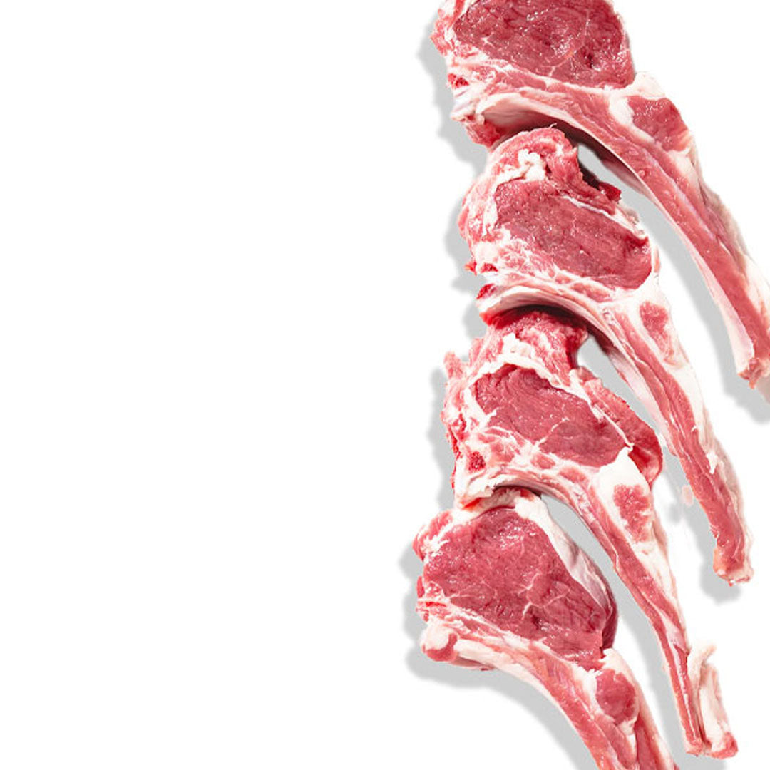 Raw lamb chops with bones on a white background