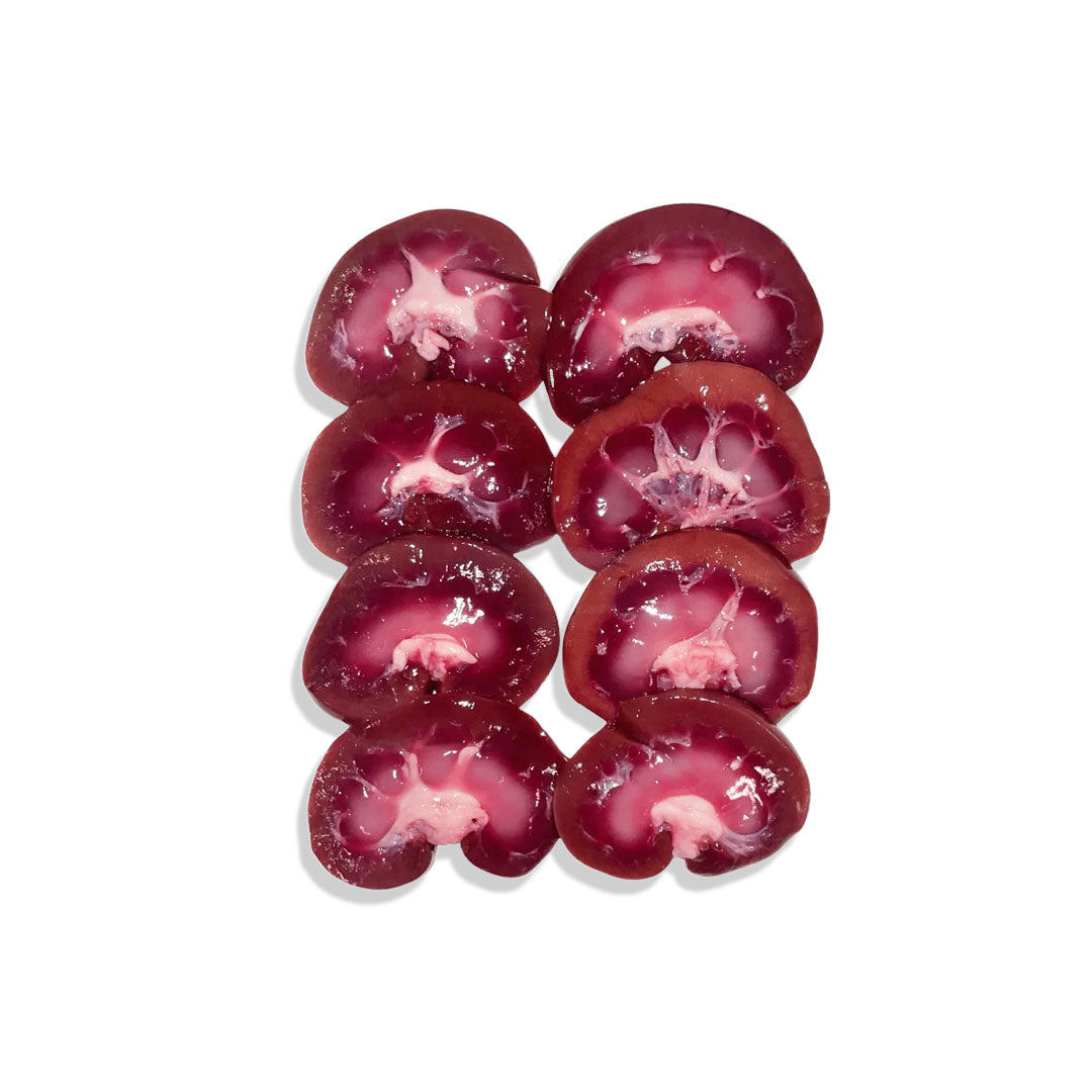 Red kidney beans arranged in a circular pattern on a white background