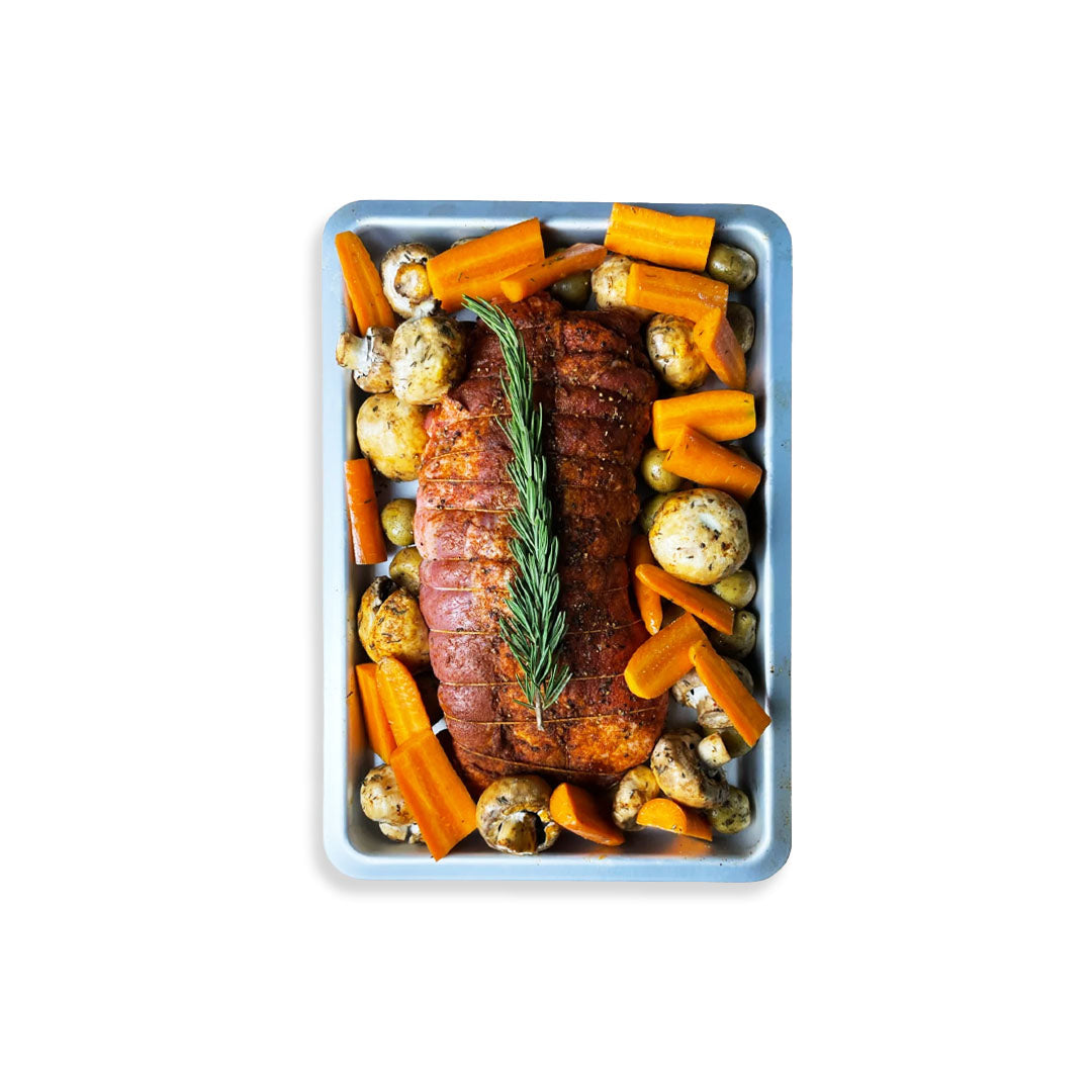 Roasted meat with vegetables on a baking tray