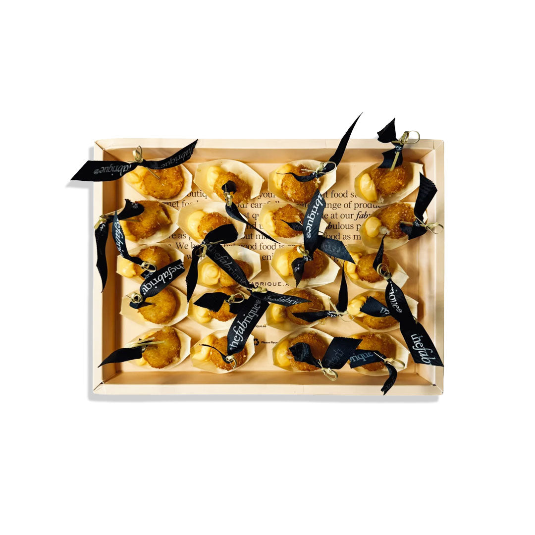 Wooden box with pears and black ribbons on a white background