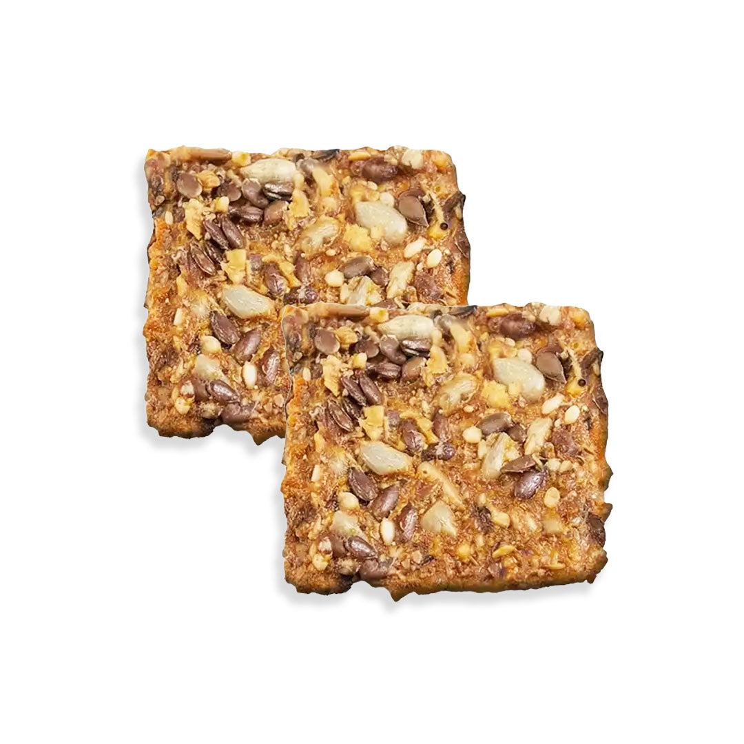Two granola bars with seeds on a white background