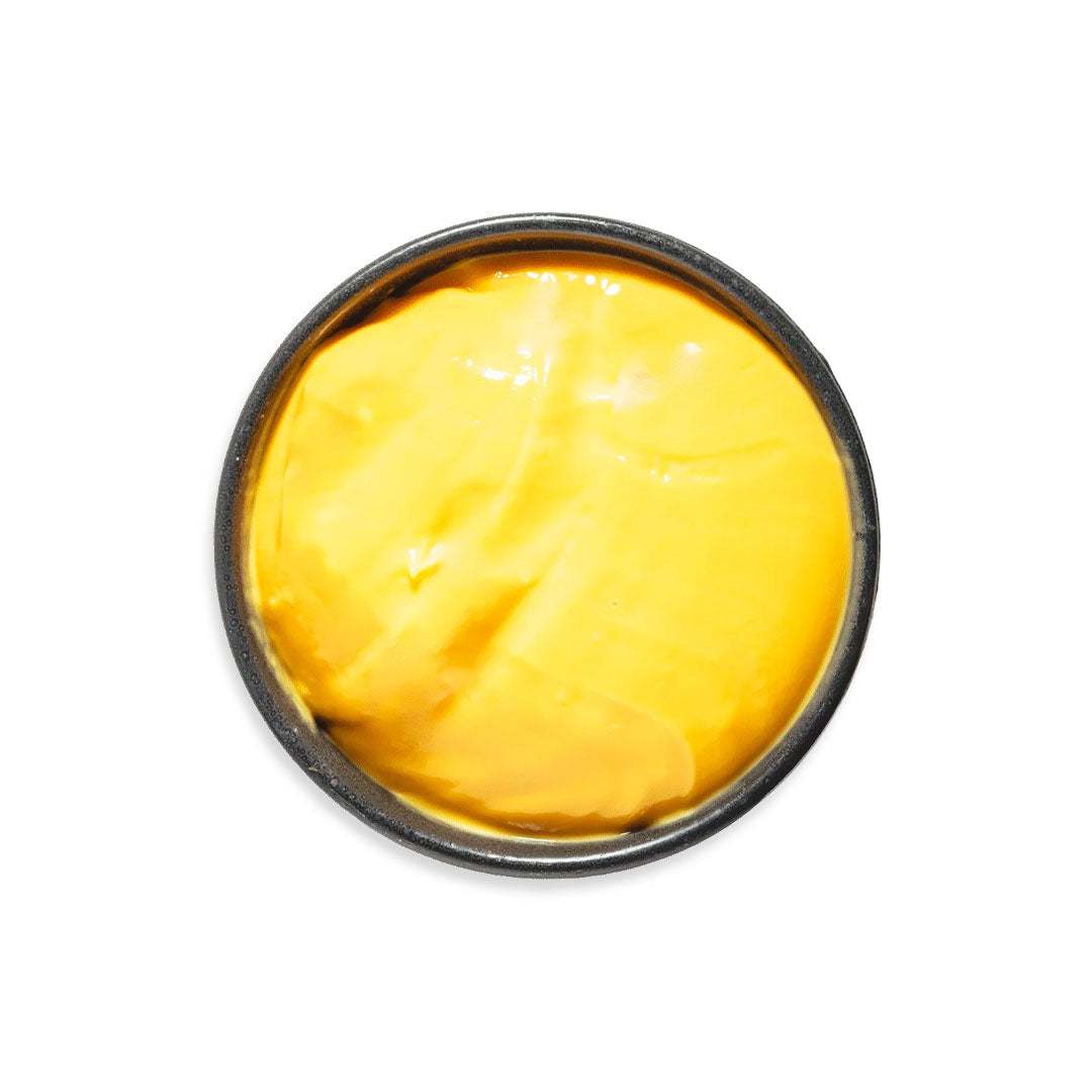 Smooth melted cheddar cheese with creamy texture ideal for drizzling on burgers and fries