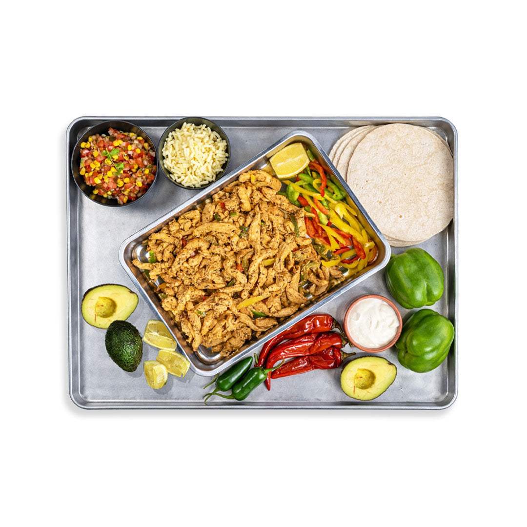 Mexican Fajita Box with tortillas, chicken or beef, sautéed peppers and onions, corn salsa, cheese, jalapeños, and lime wedges