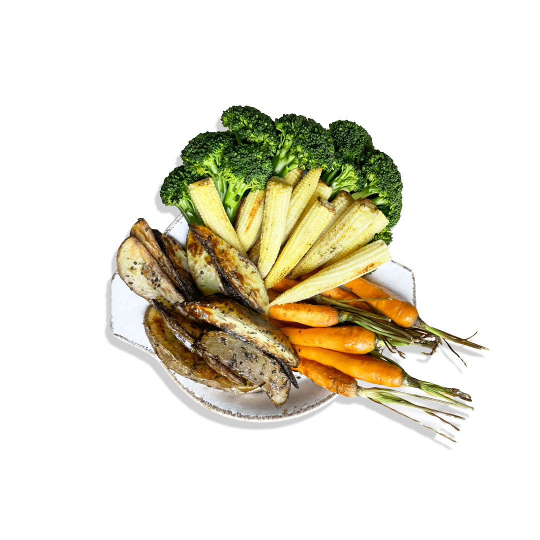 Assorted roasted vegetables including carrots, potatoes, and broccoli on a white plate.