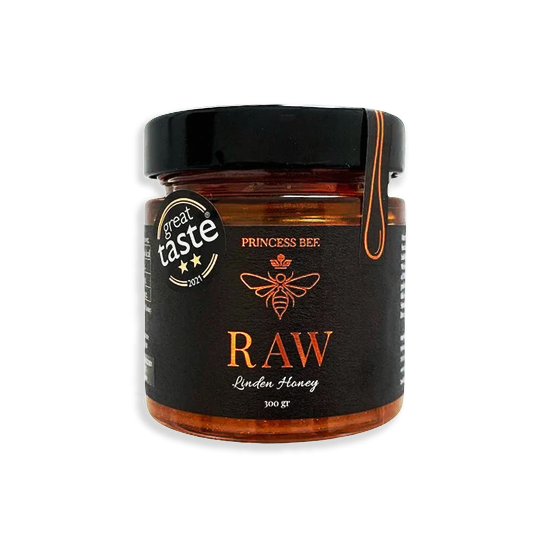 Jar of raw honey with a black label on a white background
