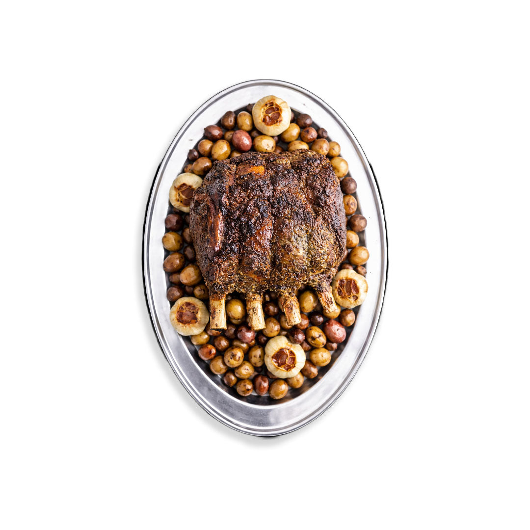 Roasted meat dish with vegetables on a white background