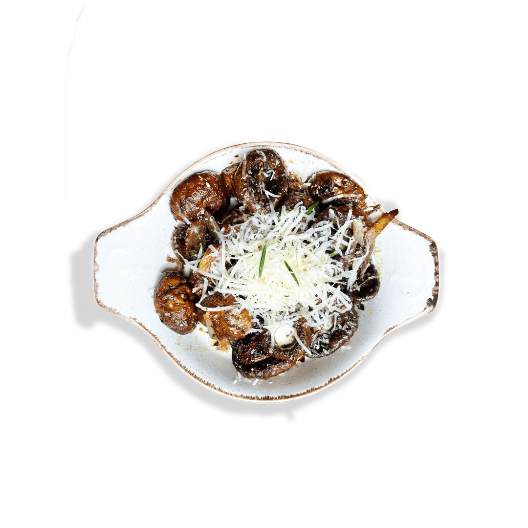 Plated dish of meatballs with parmesan cheese on a white background