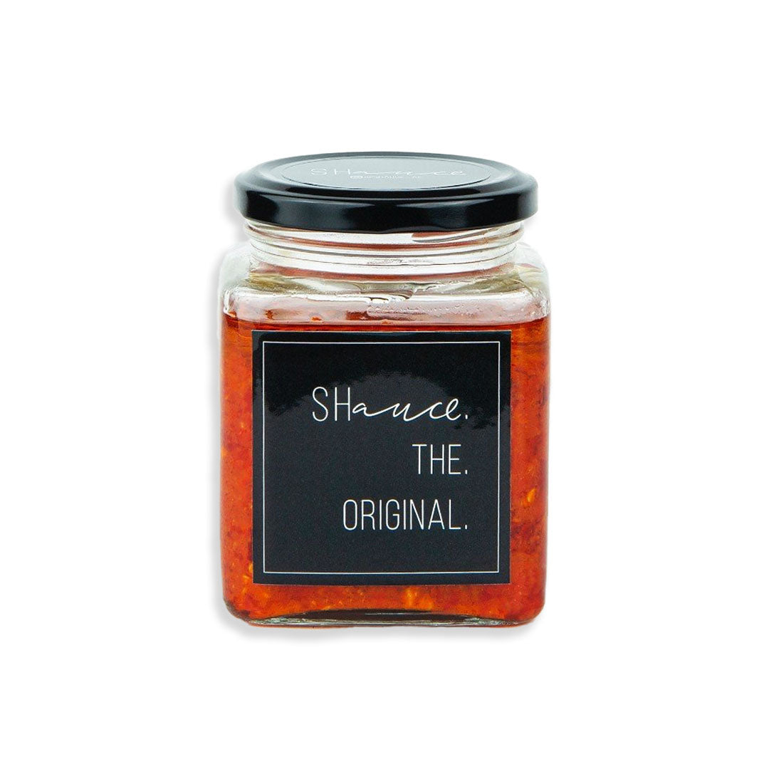 Jar of 'Shauce' with a black label on a white background
