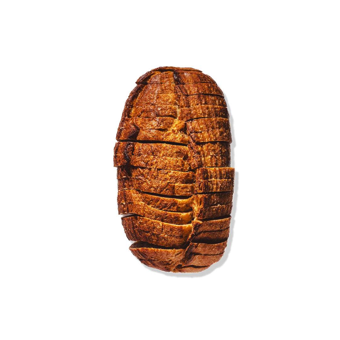 Pre-sliced sourdough loaf with crisp crust and airy interior, ideal for toasting and sandwiches