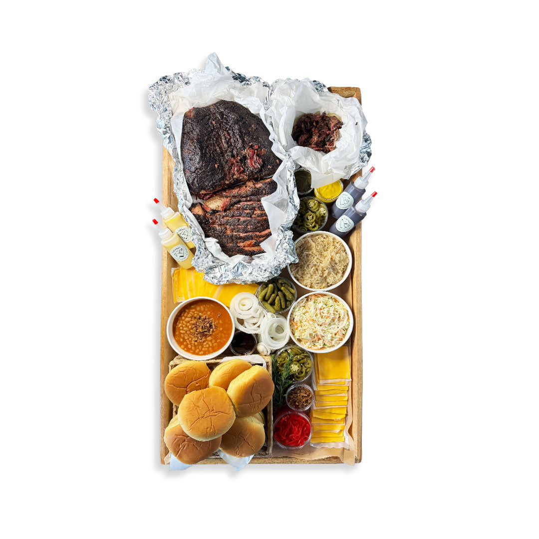 Assorted food items including a Brisket , buns, and condiments on a wooden board with a white background.
