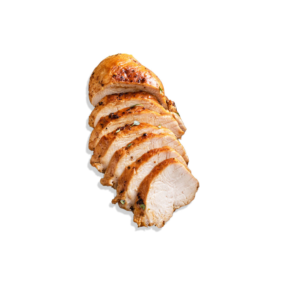 Sliced roasted chicken breast on a white background