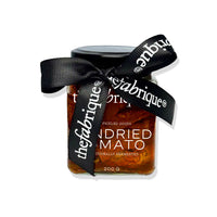 Jar of 'the fabrique' pickled goods with a black ribbon on a white background