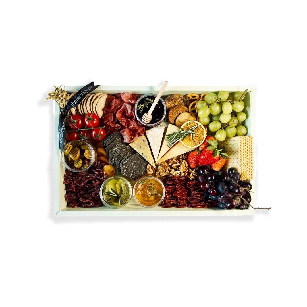 Family Cheese & Charcuterie Board with premium cheeses, cured meats, fruits, nuts, and crackers for sharing