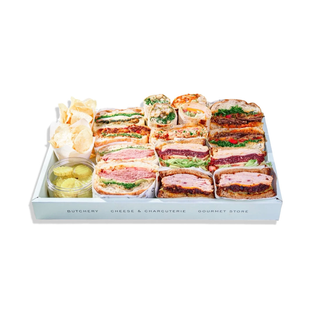 Assorted sandwiches in a box with a white background