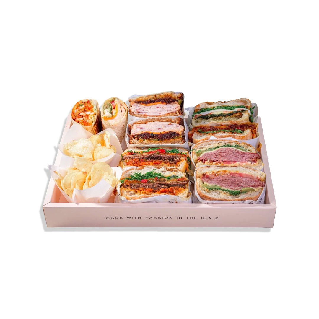Assorted sandwiches in a box with a brand name on a white background