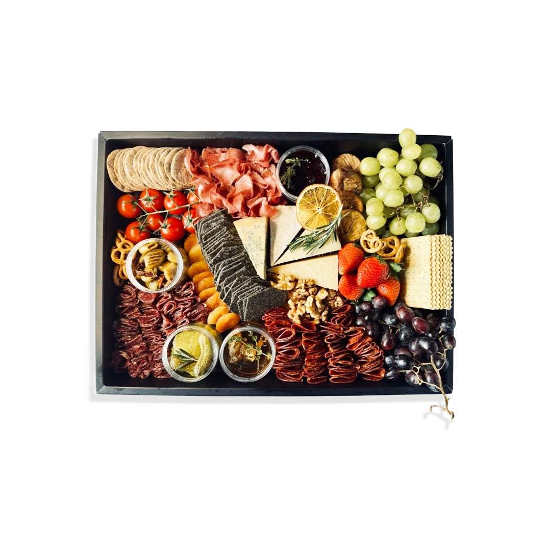 Party Cheese & Charcuterie Board with premium cheeses, cured meats, crackers, fresh fruits, and accompaniments for entertaining
