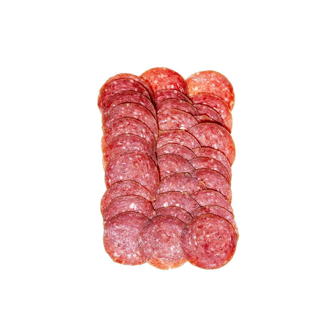 Artisanal truffle beef salami sliced on a wooden board with cheese and crackers