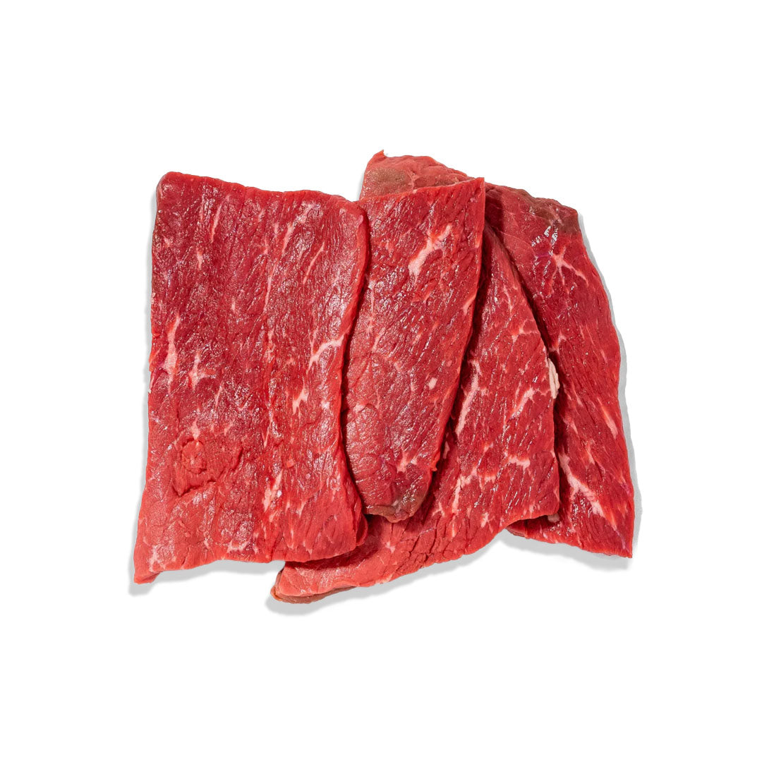 Raw beef steaks on a white background
