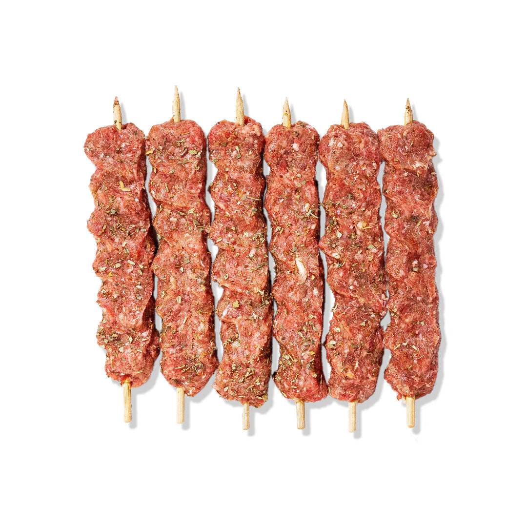 Grilled veal kofta skewers with herbs and spices served with saffron rice and vegetables