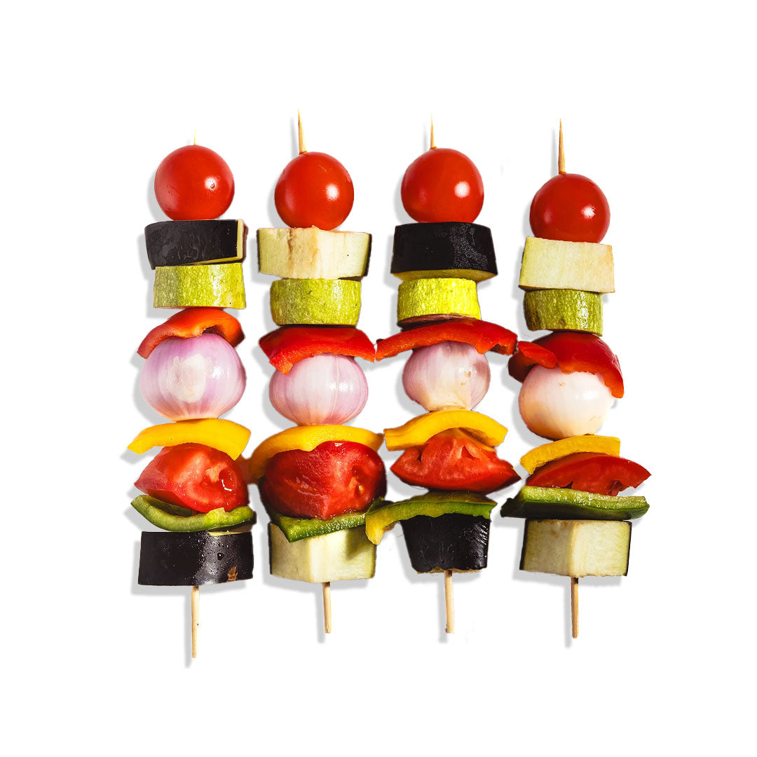 Set of vegetable skewers with cherry tomatoes, zucchini, bell peppers, and eggplant on a white background