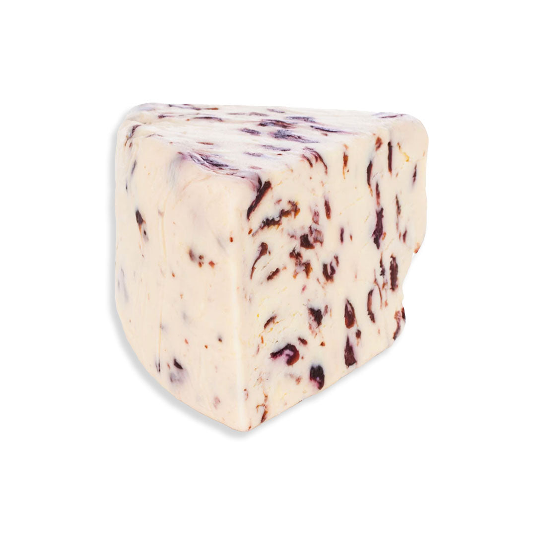 Block of cheese with visible fruit pieces on a white background