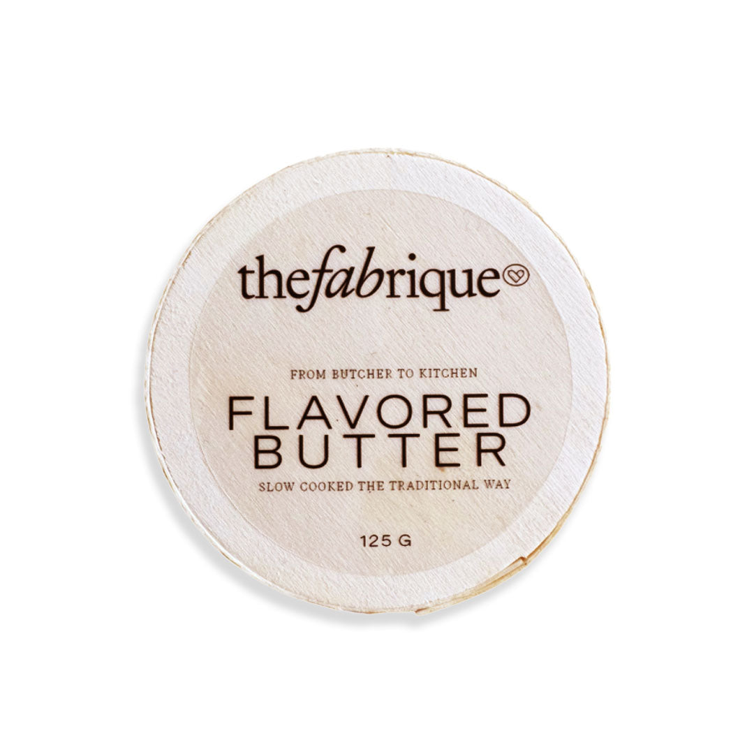 Flavored butter container with 'thefabrique' branding on a white background