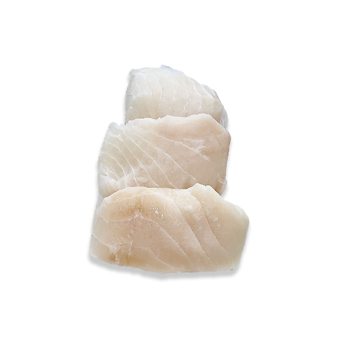 Three raw, sliced fish fillets stacked vertically on a plain white background.