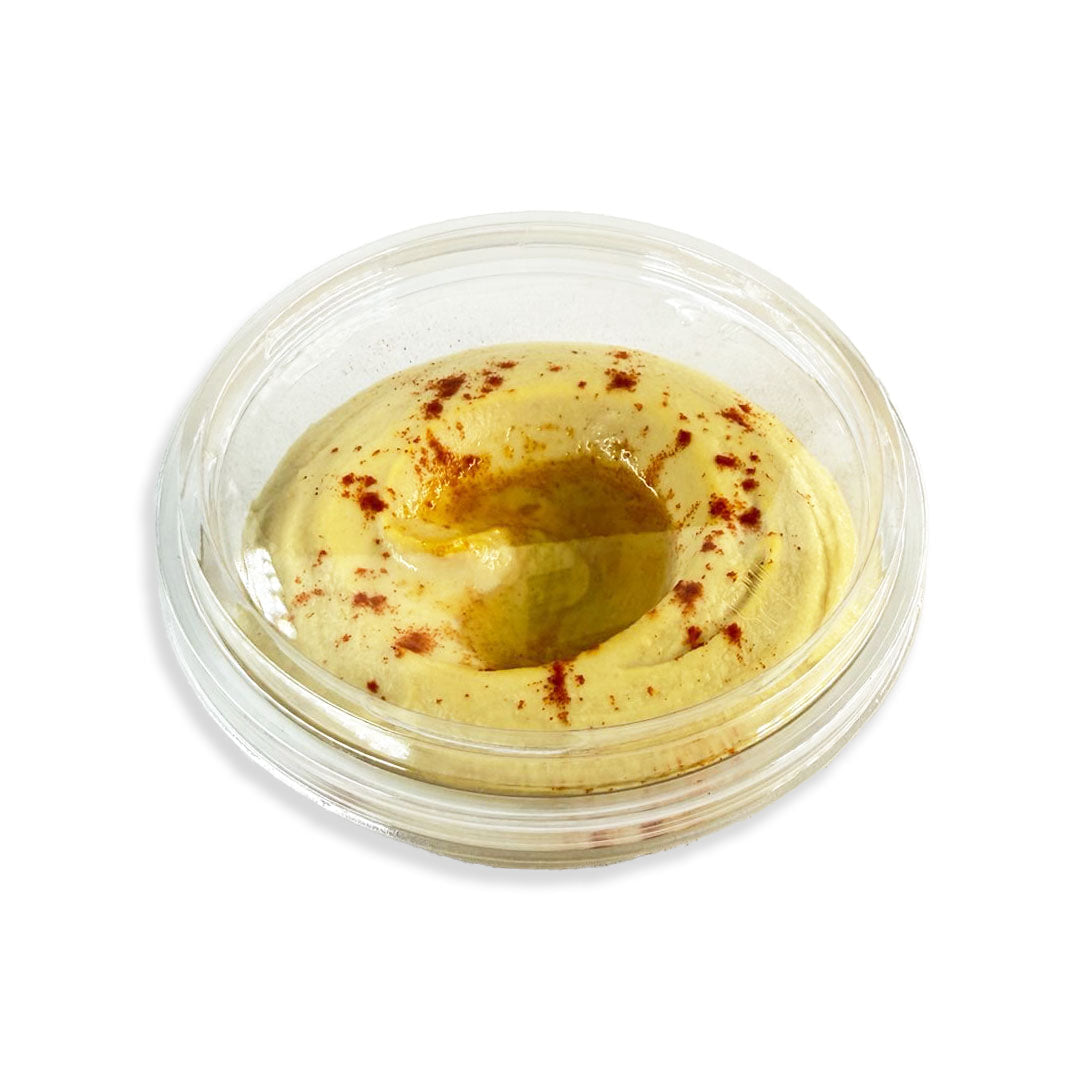 Yellow dip in a clear container with a white background