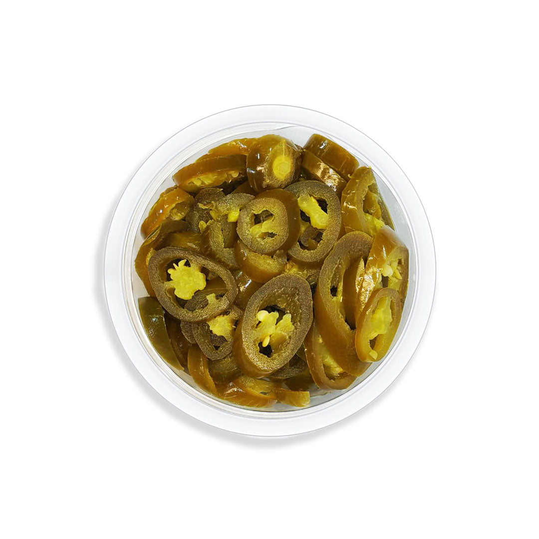 Container of sliced jalapeños on a white background