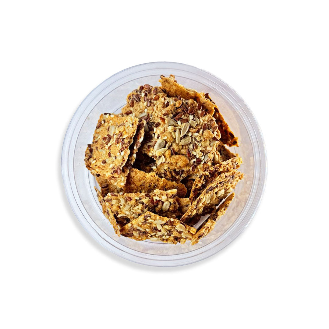 Clear container with crunchy granola-like snacks on a white background