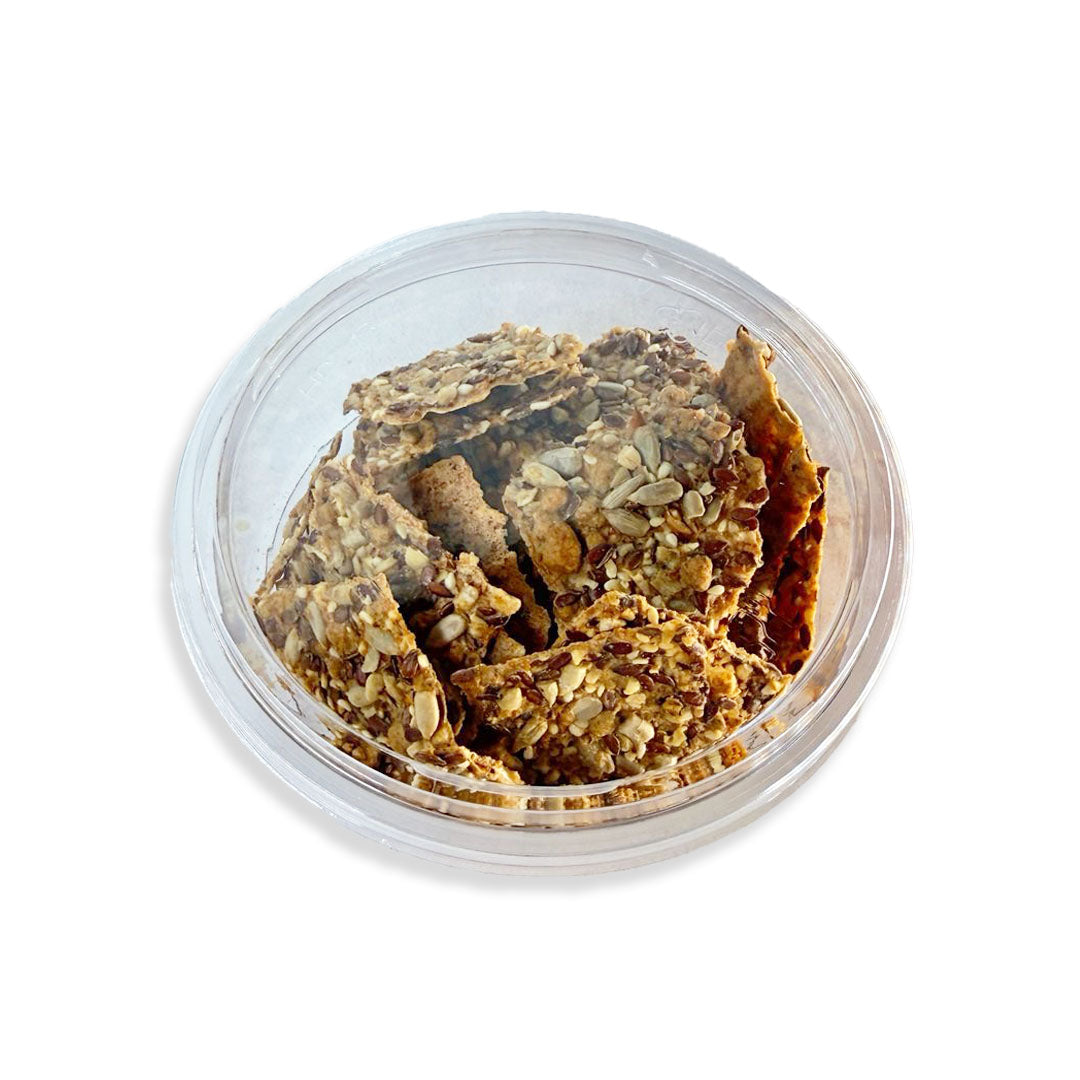 Clear container with granola-like snack on a white background