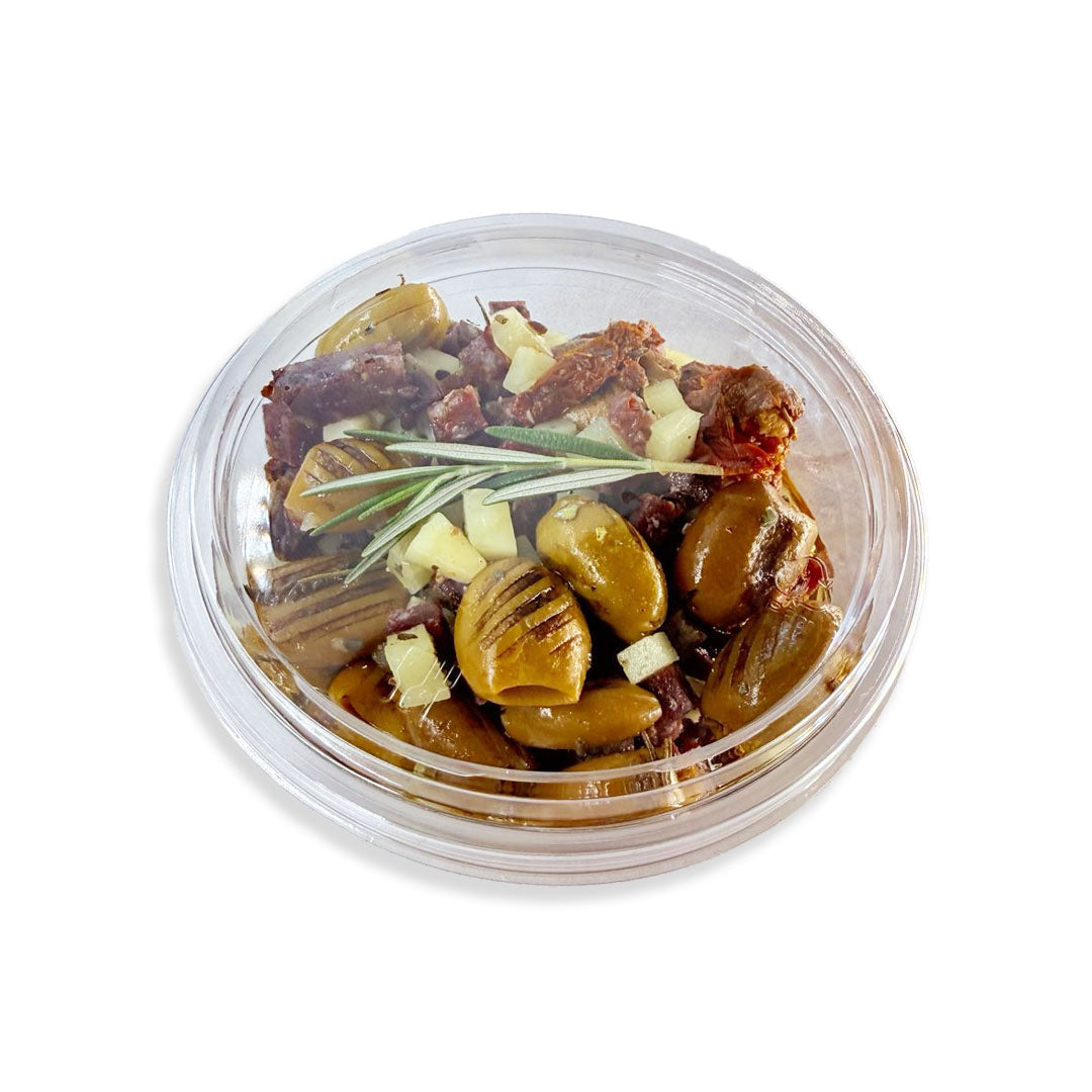 Assorted pickled vegetables in a clear plastic container on a white background